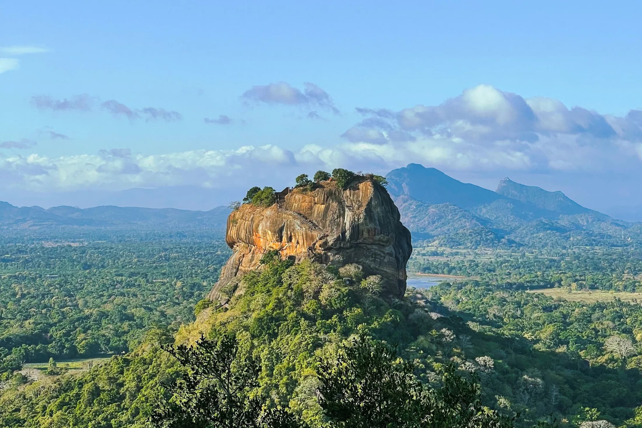 Sigiriya Rock Fortress in Sri Lanka with surrounding green landscape